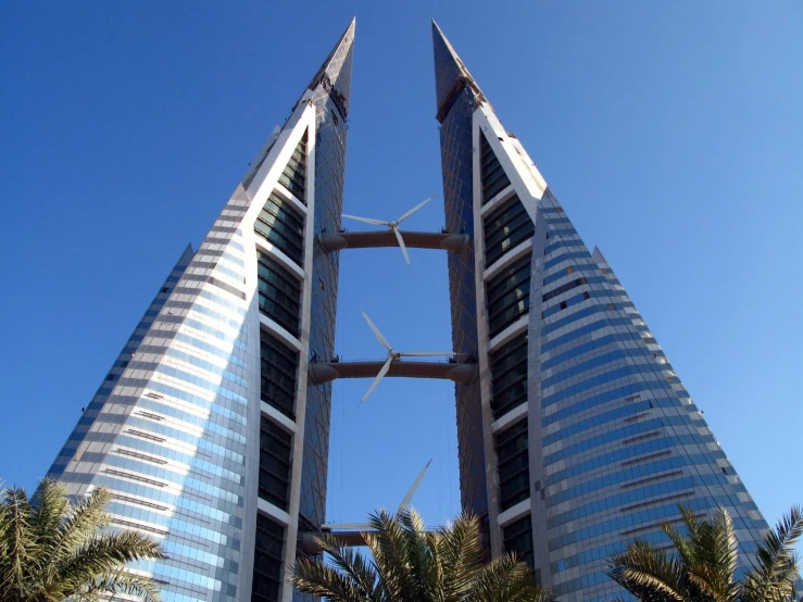 a tall tower with palm trees in front of it