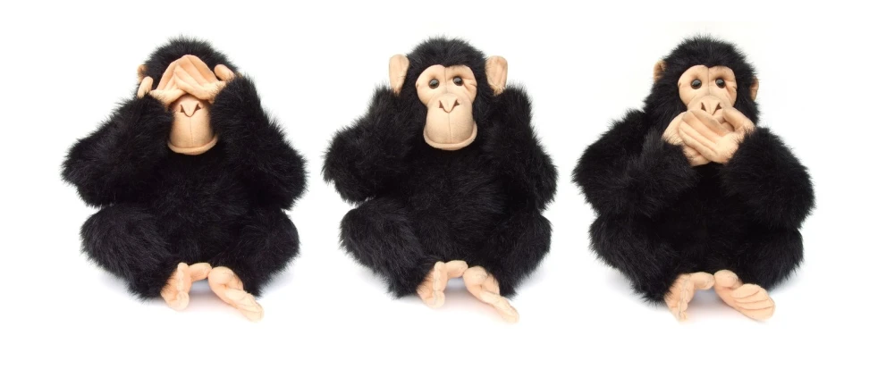 three monkey dolls sitting next to each other on white background