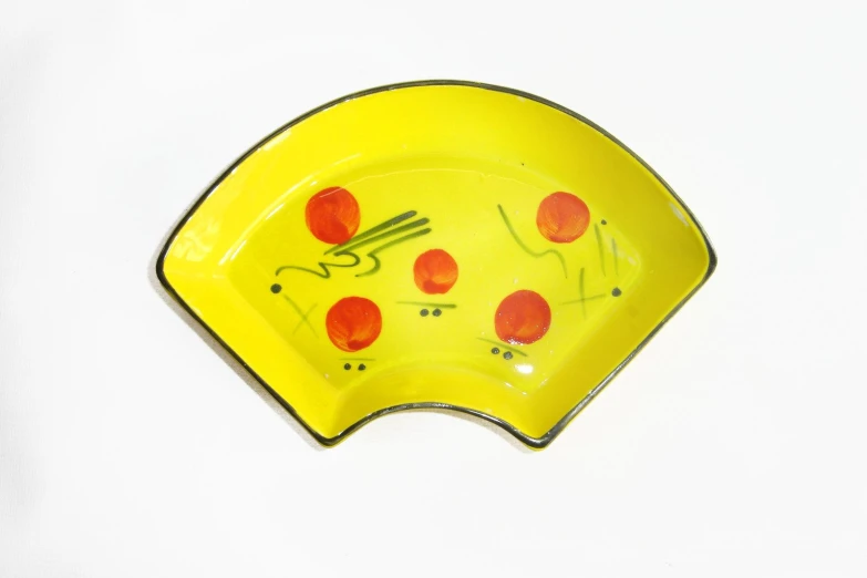 a yellow plate with the lid down and a fork in it