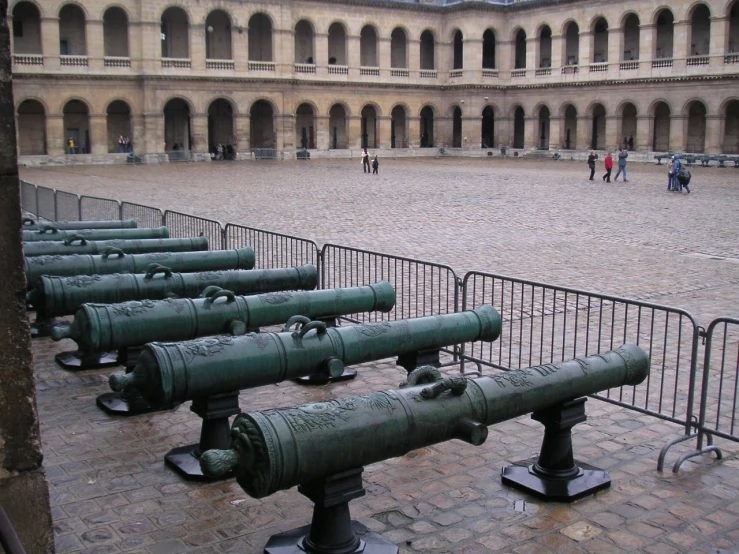 many small green tanks are in an enclosure