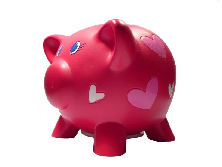 a pink piggy bank with hearts on it