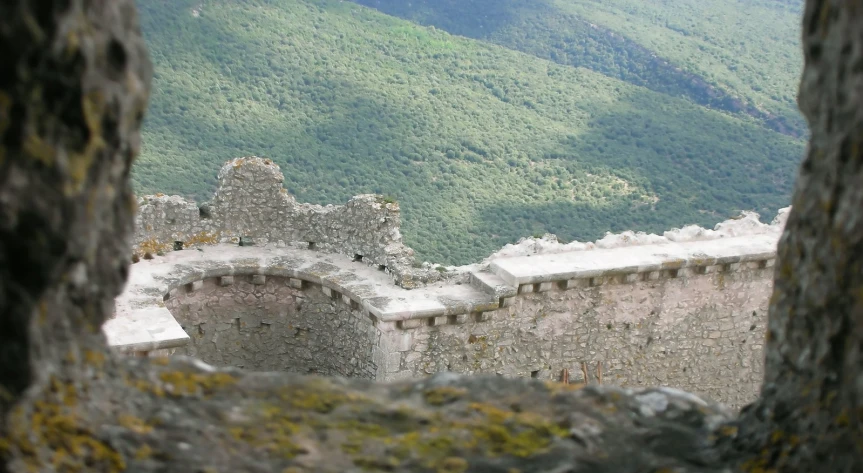 a castle is shown through a hole in a wall