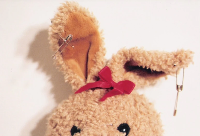 an adorable stuffed rabbit with a red bow