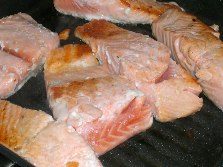 meat cooking on an open grilling pan