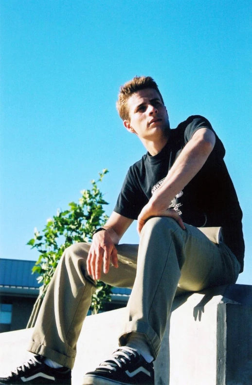 a young man is posing for the camera in his skateboard pose