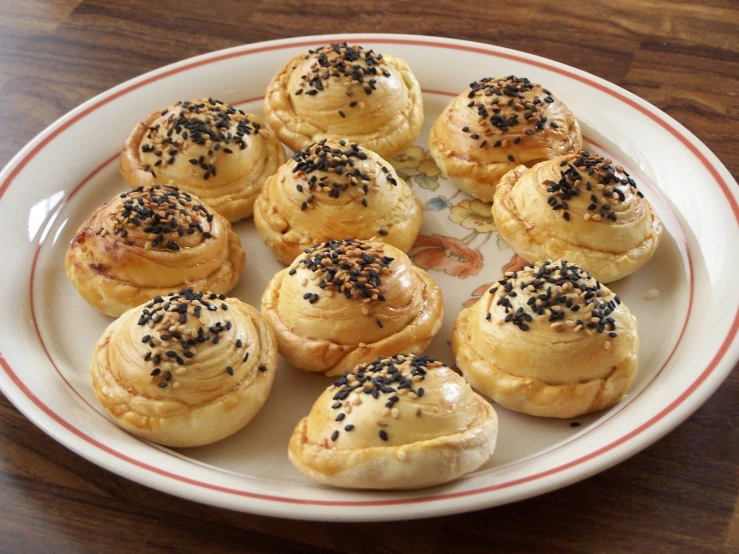 a white plate topped with mini cookies covered in sprinkles