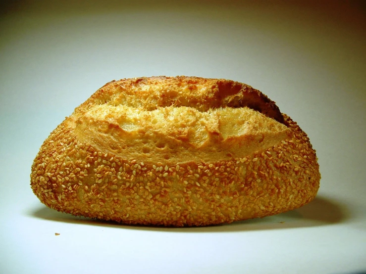 a crumbded bread sits on top of a white surface