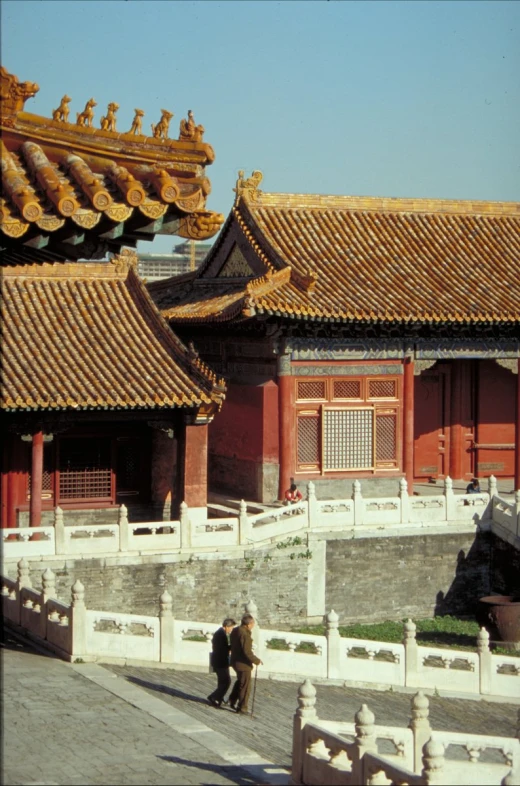 several people walking near tall building structures