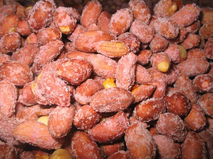 there is sugar dusted peanuts sitting in a pile