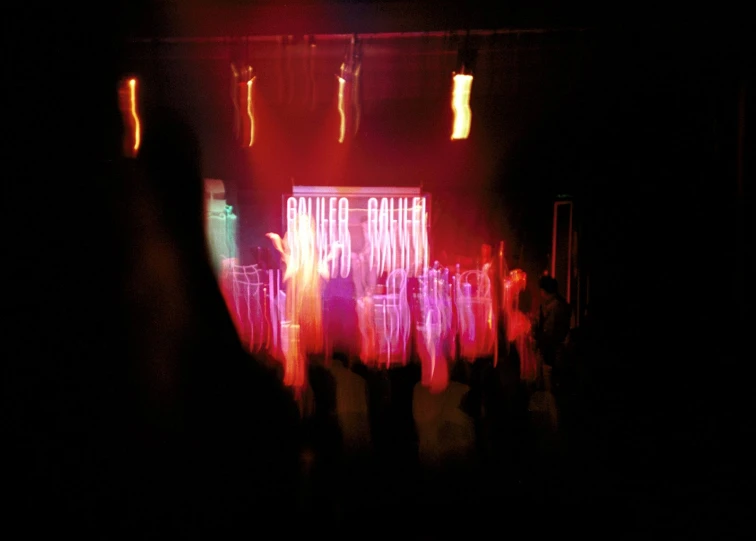 silhouettes of people dancing on a stage