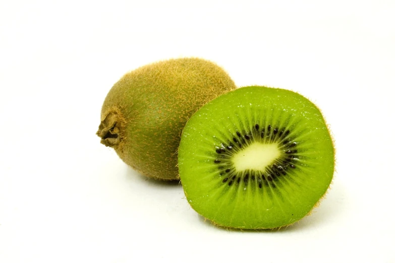 the green kiwi is cut in half and ready to eat