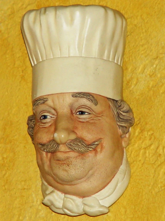 a plastic chef head on the wall