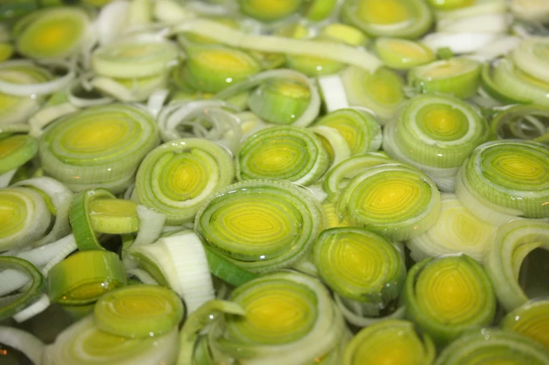 onions being cooked in water with their rings