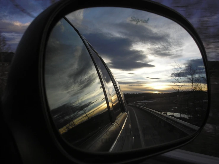 view of a road in the side mirror of a vehicle