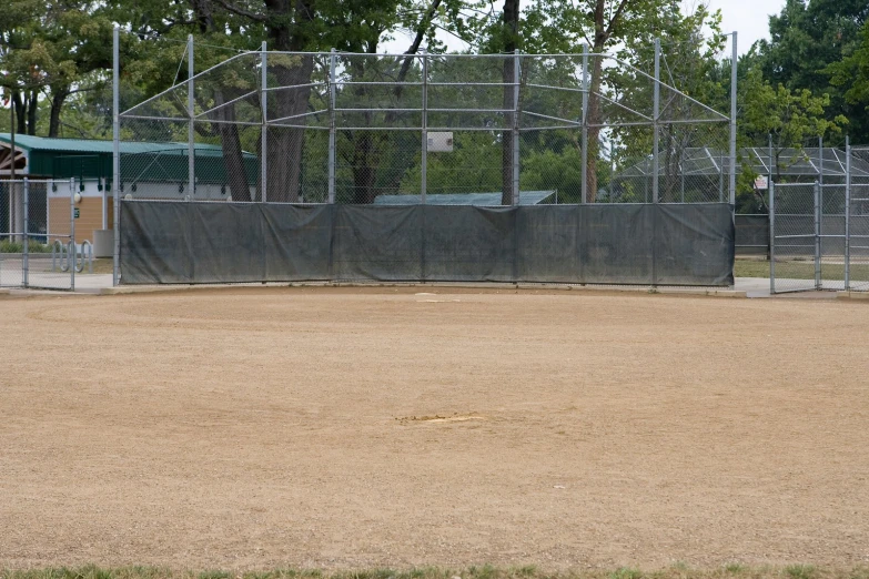 the batter's box is empty as he prepares to hit the ball