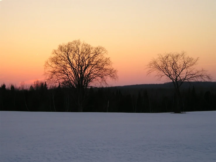 the sun sets on a beautiful winter day