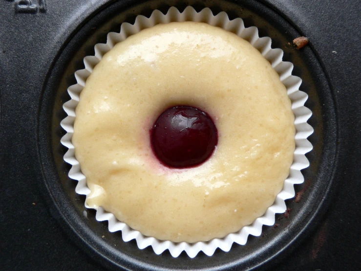 a cupcake that has a cherry in it