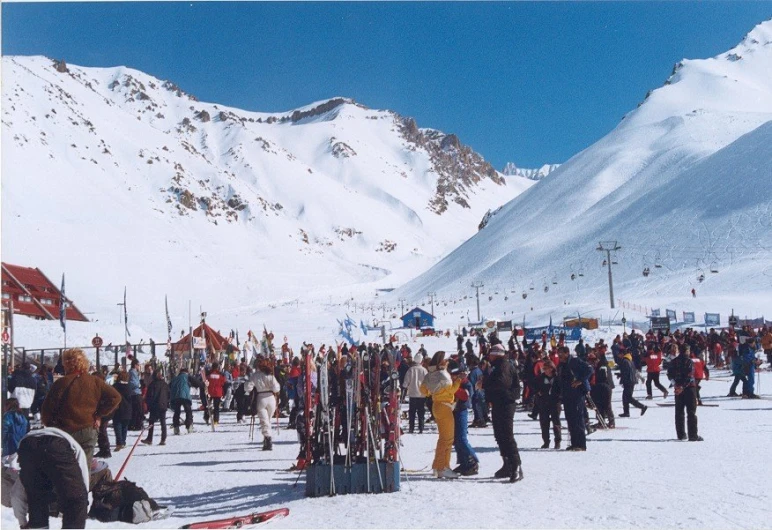 a crowd of skiers on a snow covered ski slope