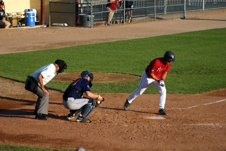 a baseball player standing at home base with the umpire behind him