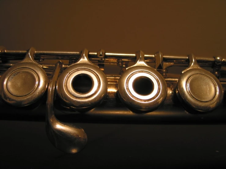 five ss bell valves and one without, and two of which appear to be part of a saxophone