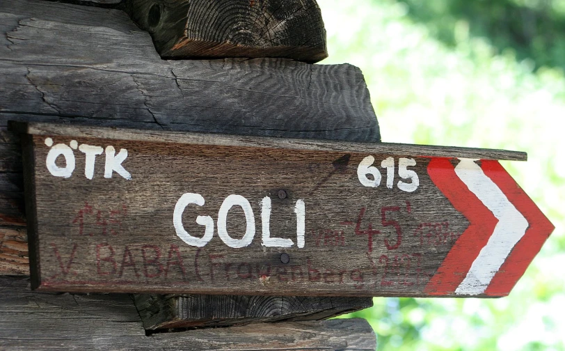 a wooden sign mounted to the side of a wooden structure