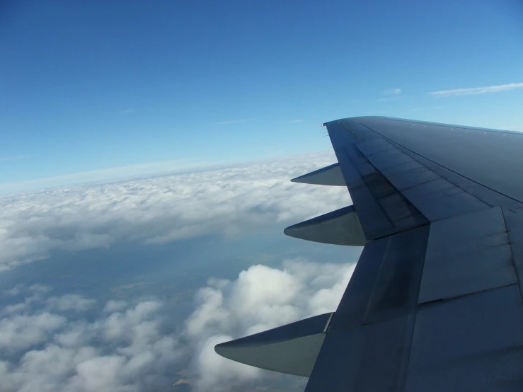 a view out an airplane window over the clouds