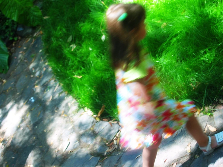 a  in a dress playing with a frisbee