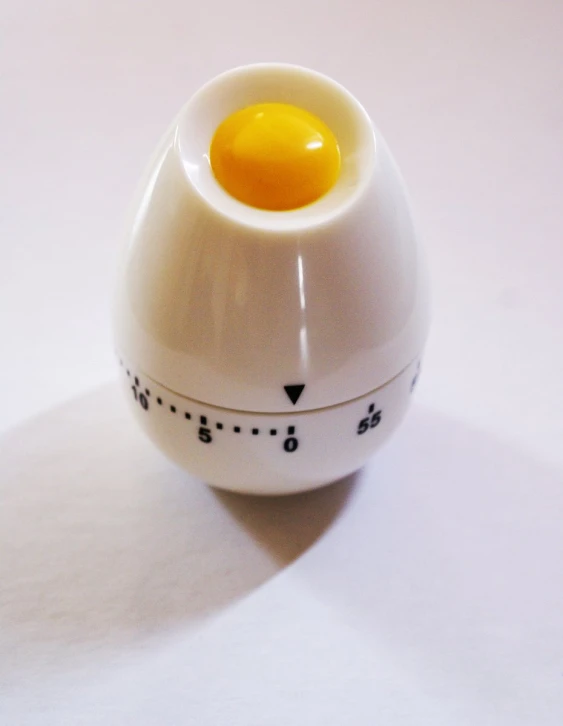 an egg sitting in a measuring cup with the scale