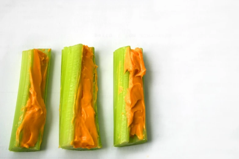 3 pieces of celery with orange dip