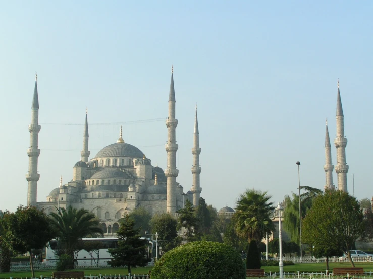 a large building with many pillars, on a clear day