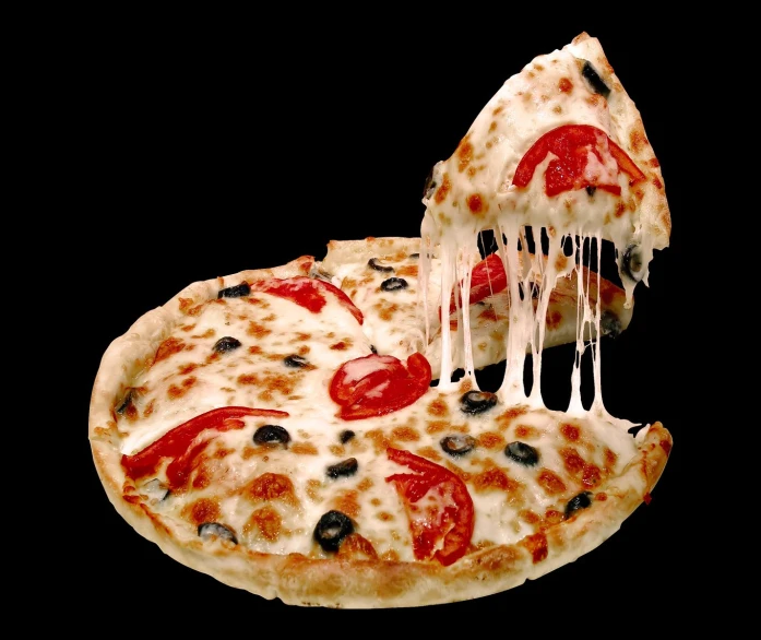 a slice of pizza with white cheese and red pepper is being held up by a fork