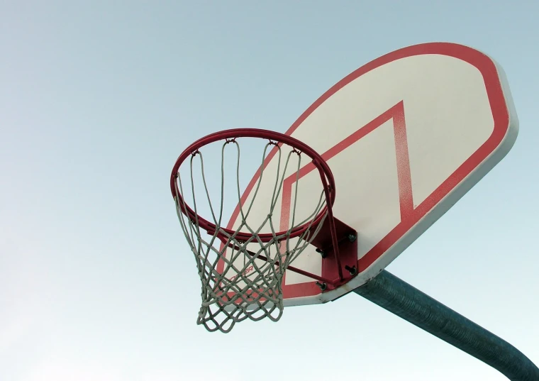 a basketball net with a red and white triangle in the middle of it