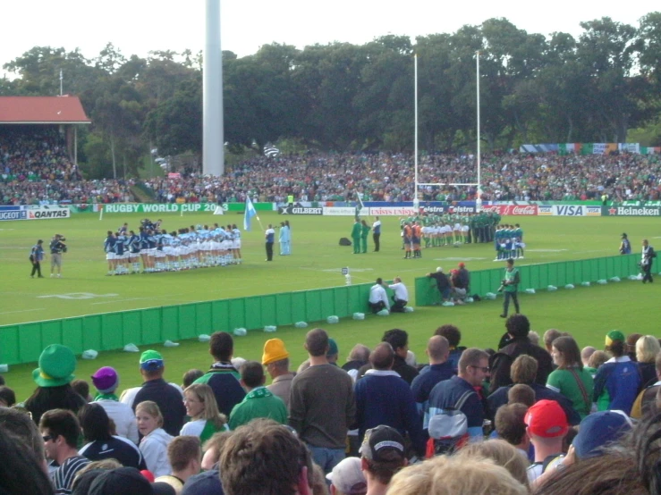 a group of people standing on top of a field