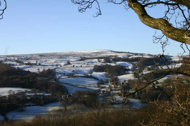 a winter landscape shows the river and fields