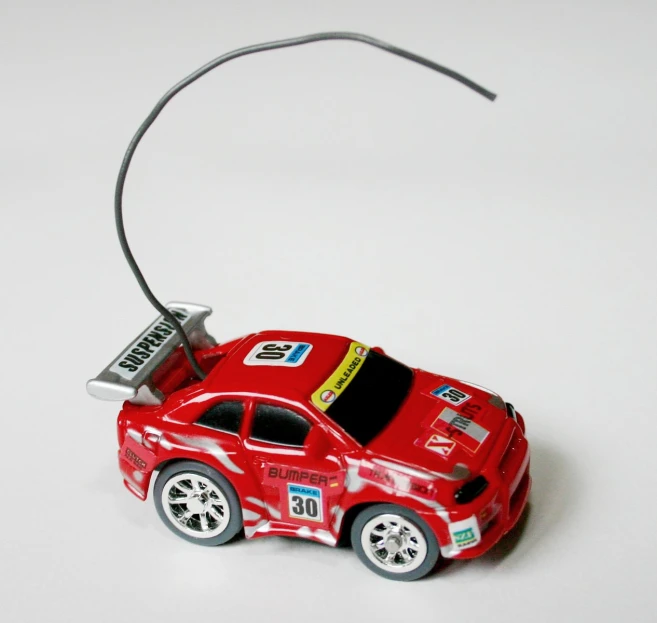 an old toy model car in red and white