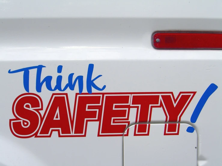 a sticker saying think safety on the back of a car