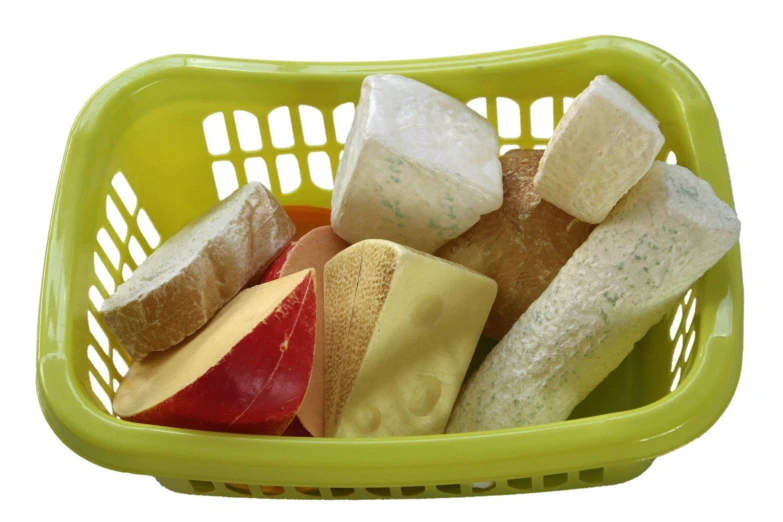 a plastic basket filled with fruit and cheese