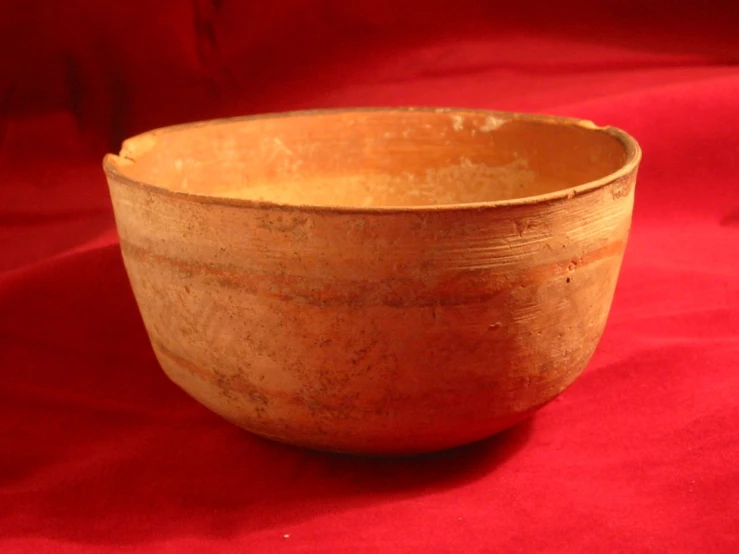 a bowl is placed on a red surface