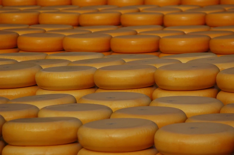 many types of cheeses are stacked high