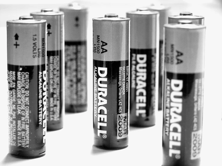 a group of six batteries on a white surface