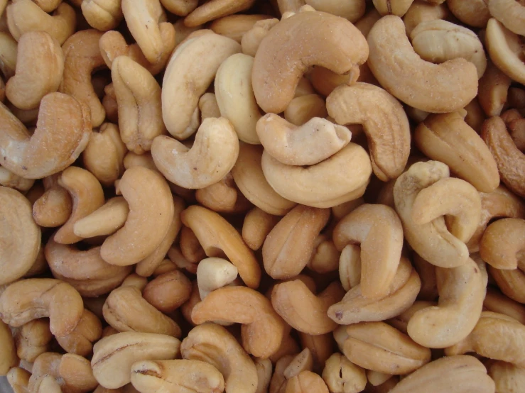 a pile of cashews sits next to each other