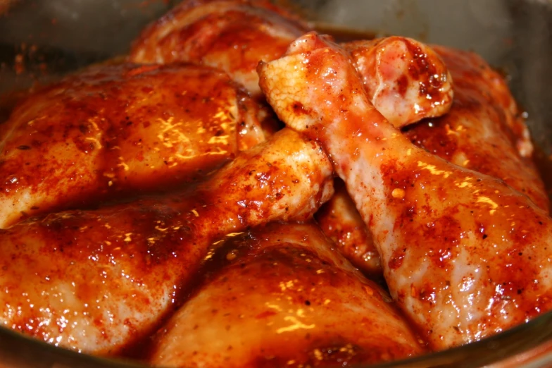 a group of sliced chicken covered in sauce