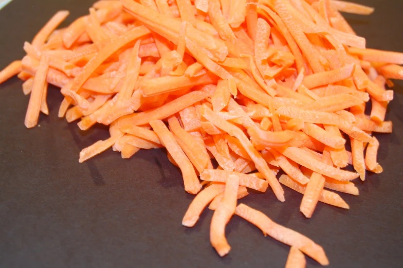 cut up carrots being peeled and sliced into bitelets
