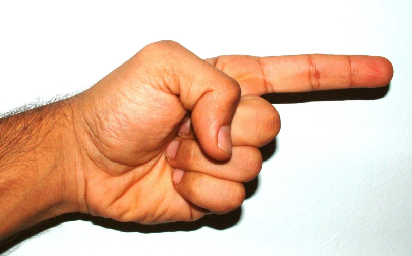 a person pointing to the right with his finger