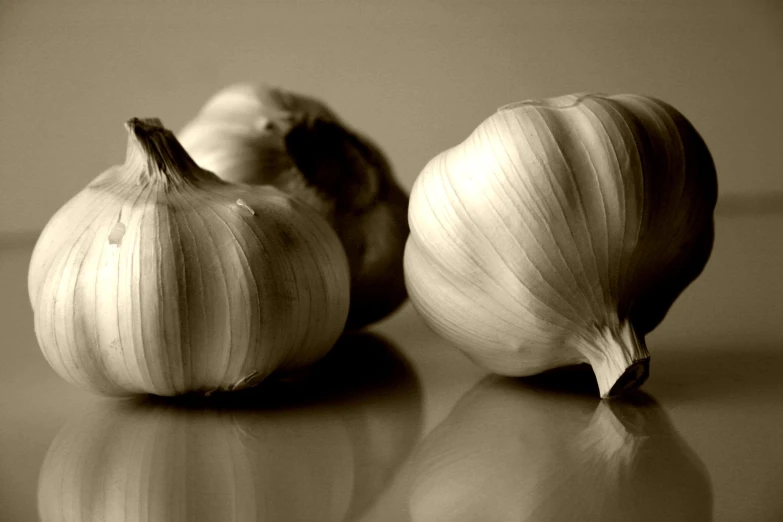 a couple of onions sitting next to each other on top of a table