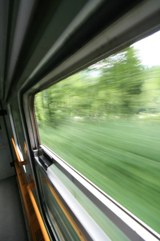 a picture looking through the side of a truck's window at the countryside