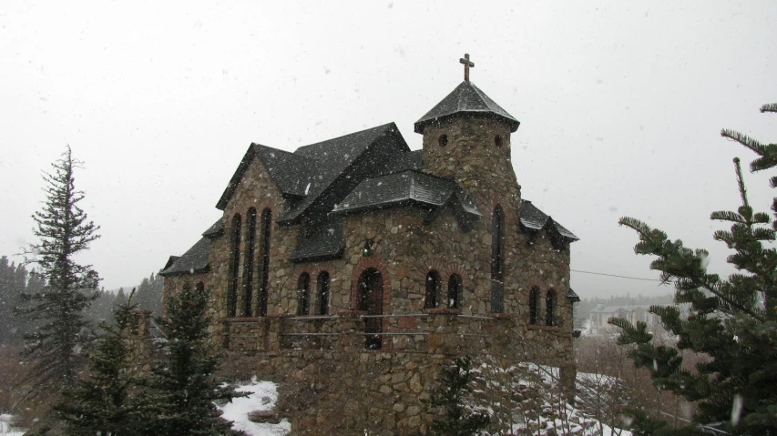 a church with an arched roof surrounded by snow
