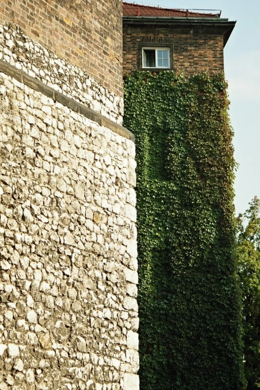 a tall tower next to some stone wall
