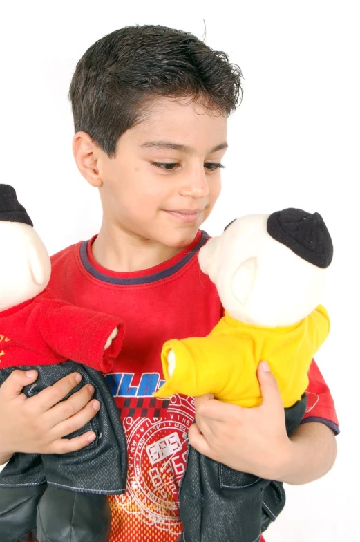 a  holds two stuffed animals in both hands