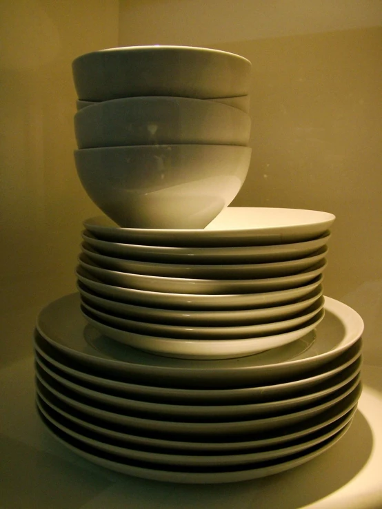 an stack of white dishes stacked on top of each other